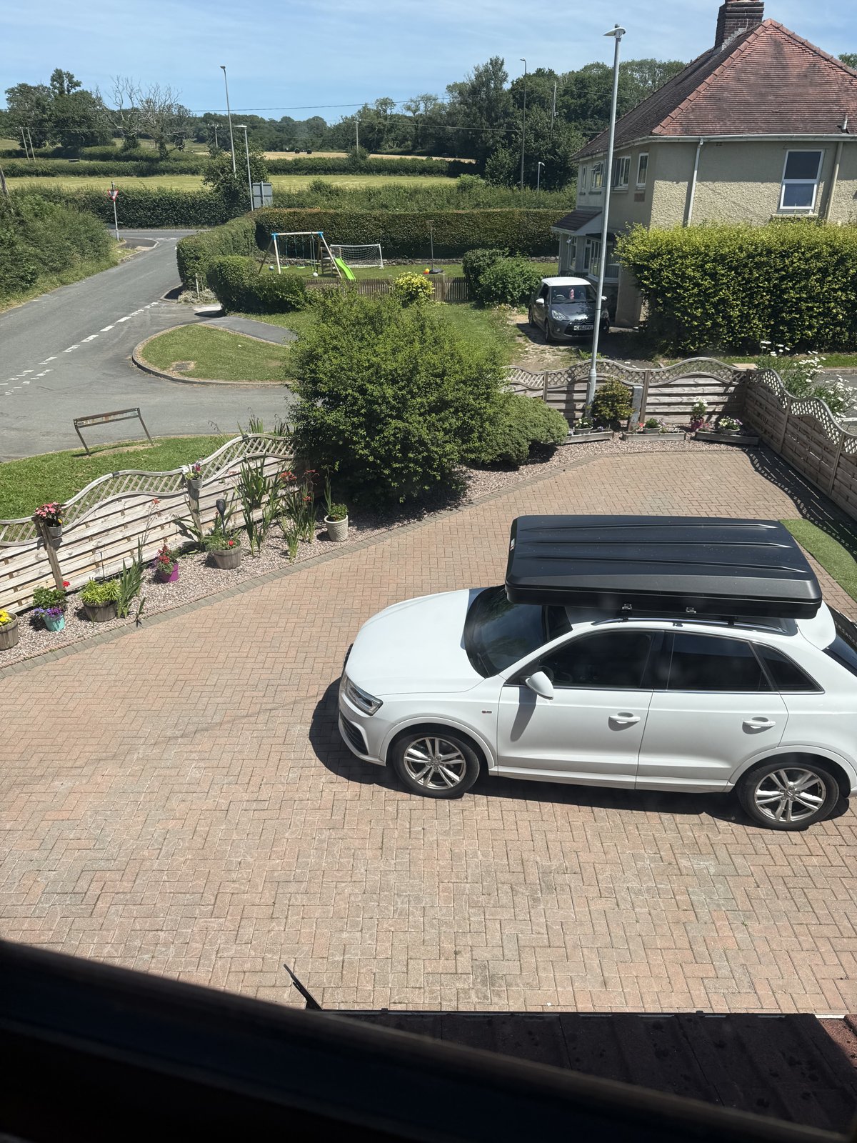 Another view of the block-paved driveway with a parked car